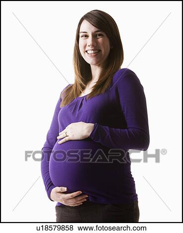 Stock Photo - Portrait of pregnant woman, studio shot. Fotosearch
