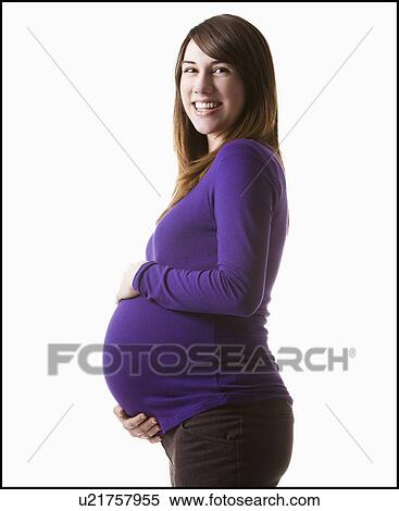 Stock Photography - Portrait of pregnant woman, studio shot. Fotosearch