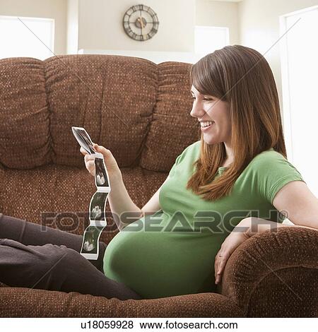 Portrait of pregnant woman watching ultrasonography scan View Large Photo Image Stock Photo - Portrait of pregnant woman watching ultrasonography scan. Fotosearch
