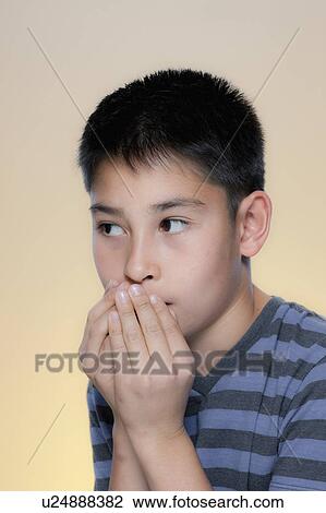Stock Image - Portrait of scared boy. Fotosearch
