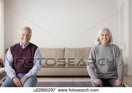 Portrait of senior couple sitting on sofa View Large Photo Image Stock Photo - Portrait of senior couple sitting on sofa. Fotosearch