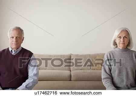 Portrait of senior couple sitting on sofa View Large Photo Image Stock Photograph - Portrait of senior couple sitting on sofa. Fotosearch