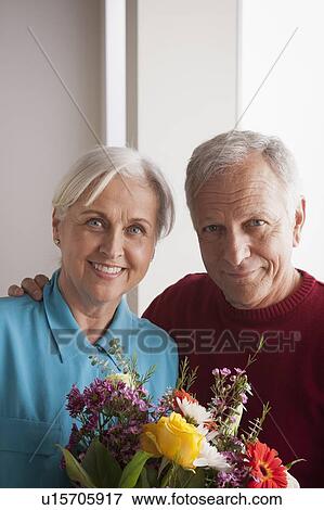 Portrait of senior couple with flowers View Large Photo Image Stock Photo - Portrait of senior couple with flowers. Fotosearch