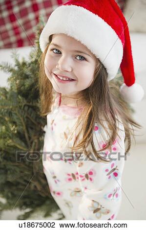 Portrait of small girl (4-5 years) in Santa hat View Large Photo Image Stock Image - Portrait of small girl (4-5 years) in Santa hat. Fotosearch