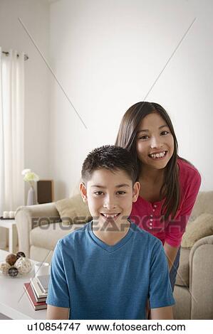 Portrait of smiling brother (10-11) and sister (12-13) View Large Photo Image Stock Photo - Portrait of smiling brother (10-11) and sister (12-13). Fotosearch