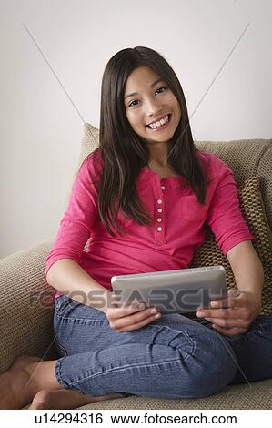 Portrait of smiling girl (12-13) using digital tablet View Large Photo Image Stock Photograph - Portrait of smiling girl (12-13) using digital tablet. Fotosearch
