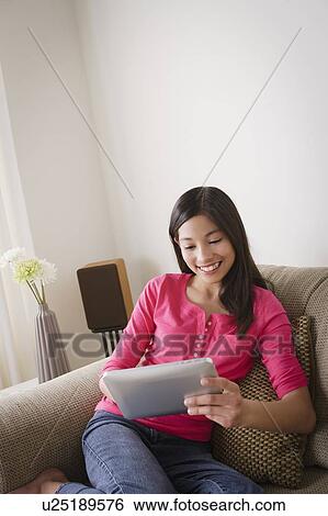 Portrait of smiling girl (12-13) using digital tablet View Large Photo Image Stock Photograph - Portrait of smiling girl (12-13) using digital tablet. Fotosearch