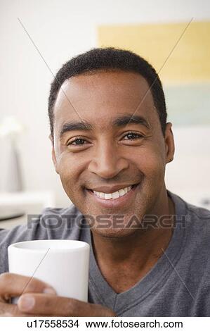 Picture - Portrait of smiling mature man holding mug. Fotosearch