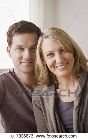 Stock Image - Portrait of smiling mid adult couple. Fotosearch