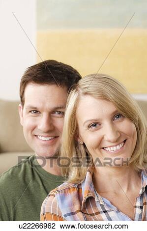 Stock Image - Portrait of smiling mid adult couple. Fotosearch