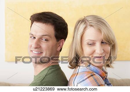 Stock Photo - Portrait of smiling mid adult couple. Fotosearch