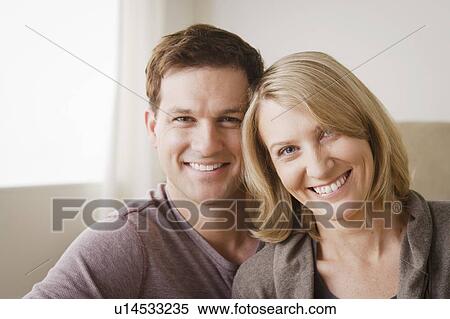 Portrait of smiling mid adult couple View Large Photo Image Stock Photography - Portrait of smiling mid adult couple. Fotosearch