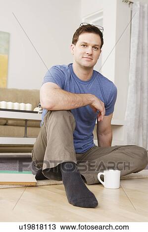 Portrait of smiling mid adult man sitting on floor View Large Photo Image Stock Image - Portrait of smiling mid adult man sitting on floor. Fotosearch