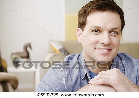 Stock Photo - Portrait of smiling mid adult man. Fotosearch