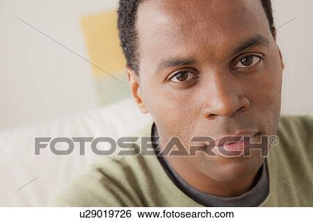 Stock Photograph - Portrait of smiling mid adult man. Fotosearch