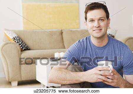 Portrait of smiling mid adult man holding mug View Large Photo Image Stock Photography - Portrait of smiling mid adult man holding mug. Fotosearch