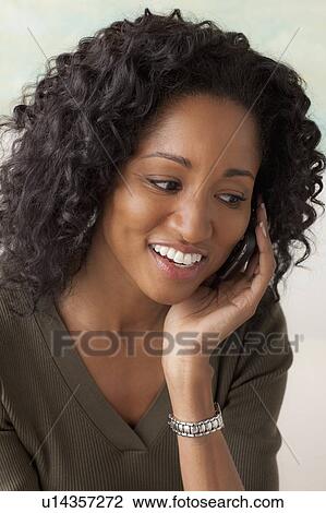 Stock Image - Portrait of smiling mid adult woman. Fotosearch