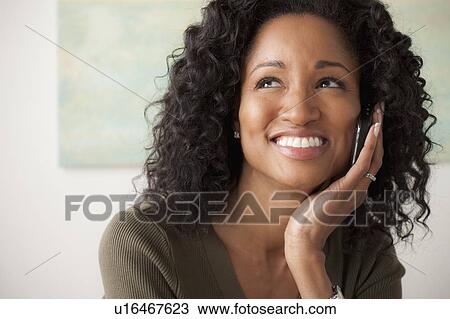Portrait of smiling mid adult woman talking via mobile View Large Photo Image Stock Image - Portrait of smiling mid adult woman talking via mobile. Fotosearch