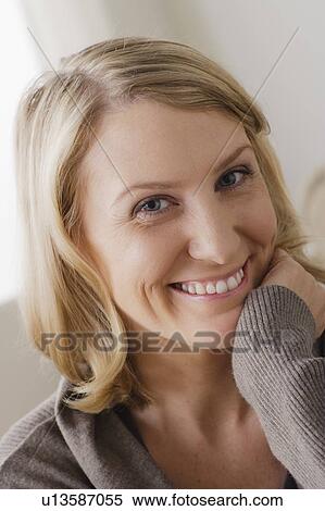 Stock Photography - Portrait of smiling mid adult woman. Fotosearch