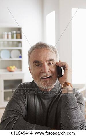 Portrait of smiling senior man talking via mobile View Large Photo Image Picture - Portrait of smiling senior man talking via mobile. Fotosearch