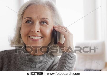 Portrait of smiling senior woman using mobile View Large Photo Image Stock Image - Portrait of smiling senior woman using mobile. Fotosearch