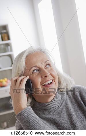 Portrait of smiling senior woman using mobile View Large Photo Image Stock Image - Portrait of smiling senior woman using mobile. Fotosearch