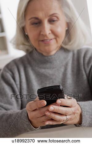 Portrait of smiling senior woman using mobile View Large Photo Image Stock Image - Portrait of smiling senior woman using mobile. Fotosearch