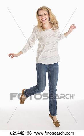 Stock Photograph - Portrait of smiling woman, studio shot. Fotosearch