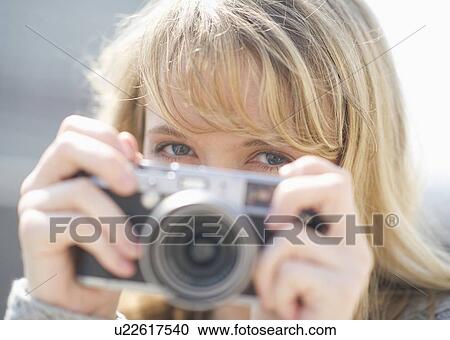 Portrait of smiling woman with camera View Large Photo Image Stock Image - Portrait of smiling woman with camera. Fotosearch
