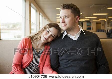 Stock Photograph - Portrait of smiling young couple. Fotosearch