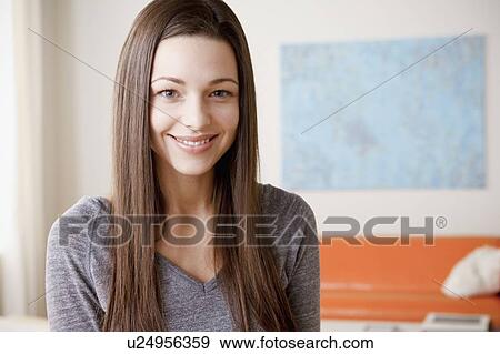 Portrait of smiling young woman View Large Photo Image Stock Photo - Portrait of smiling young woman. Fotosearch