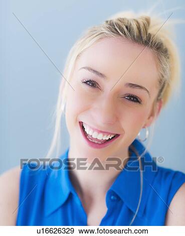 Portrait of smiling young woman, studio shot View Large Photo Image Stock Photo - Portrait of smiling young woman, studio shot. Fotosearch