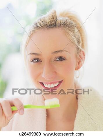 Portrait of smiling young woman with toothbrush View Large Photo Image Stock Image - Portrait of smiling young woman with toothbrush. Fotosearch