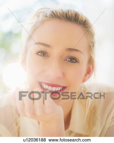 Stock Photo - Portrait of smiling young woman with blonde hair. Fotosearch