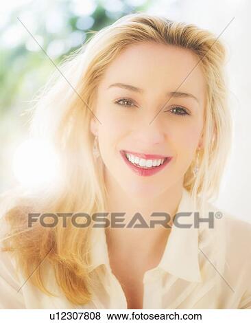 Portrait of smiling young woman with blonde hair View Large Photo Image Stock Photo - Portrait of smiling young woman with blonde hair. Fotosearch
