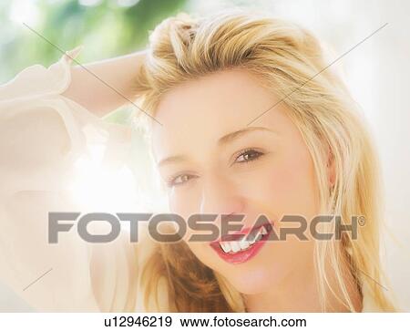 Portrait of smiling young woman with blonde hair View Large Photo Image Stock Photo - Portrait of smiling young woman with blonde hair. Fotosearch