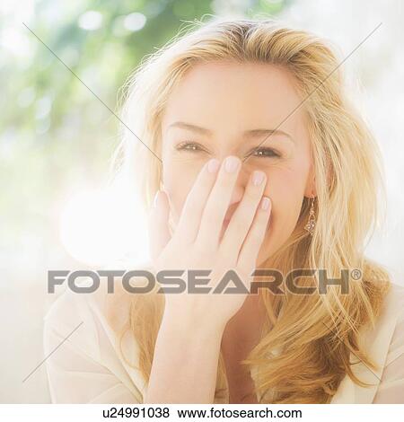 Stock Photo - Portrait of smiling young woman with blonde hair. Fotosearch