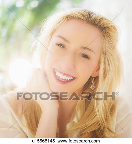 Stock Photography - Portrait of smiling young woman with blonde hair. Fotosearch