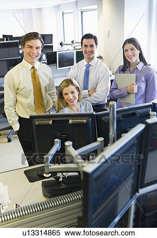 Stock Photography - Portrait of traders at trading desk. Fotosearch