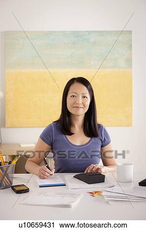 Portrait of woman doing paperwork View Large Photo Image Stock Image - Portrait of woman doing paperwork. Fotosearch