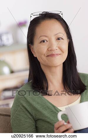 Portrait of woman holding cup View Large Photo Image Stock Photograph - Portrait of woman holding cup. Fotosearch