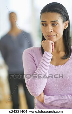 Picture - Portrait of woman, man in background. Fotosearch