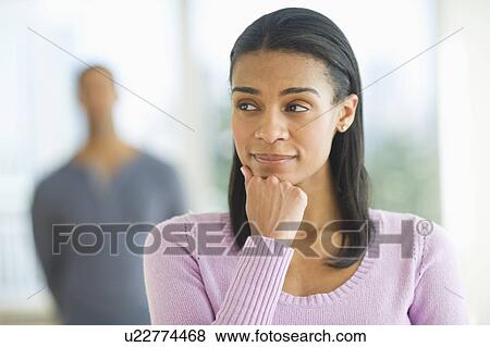 Portrait of woman, man in background View Large Photo Image Stock Photo - Portrait of woman, man in background. Fotosearch