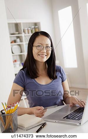 Portrait of woman shopping online from home View Large Photo Image Stock Image - Portrait of woman shopping online from home. Fotosearch