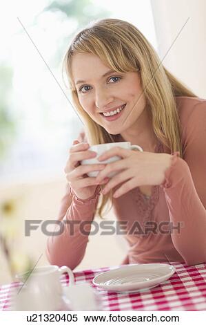 Portrait of woman sitting at table View Large Photo Image Stock Photography - Portrait of woman sitting at table. Fotosearch