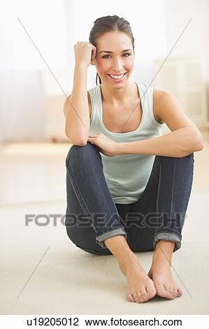Portrait of woman sitting on floor and smiling View Large Photo Image Stock Image - Portrait of woman sitting on floor and smiling. Fotosearch