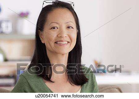Stock Image - Portrait of woman smiling. Fotosearch