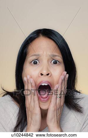 Stock Image - Portrait of woman with astonished expression. Fotosearch