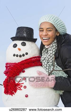 Stock Photo - Portrait of woman with snowman. Fotosearch