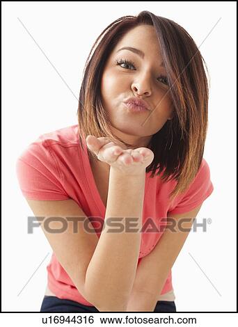 Portrait of young happy woman blowing kiss View Large Photo Image Stock Photograph - Portrait of young happy woman blowing kiss. Fotosearch